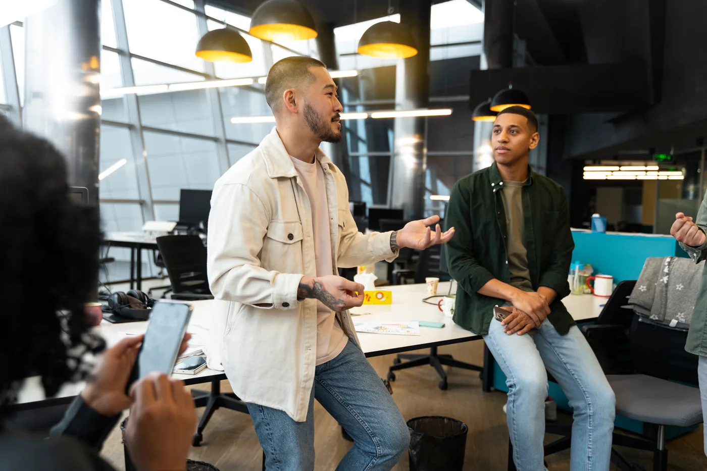 Colleagues discussing work in a modern open-plan office